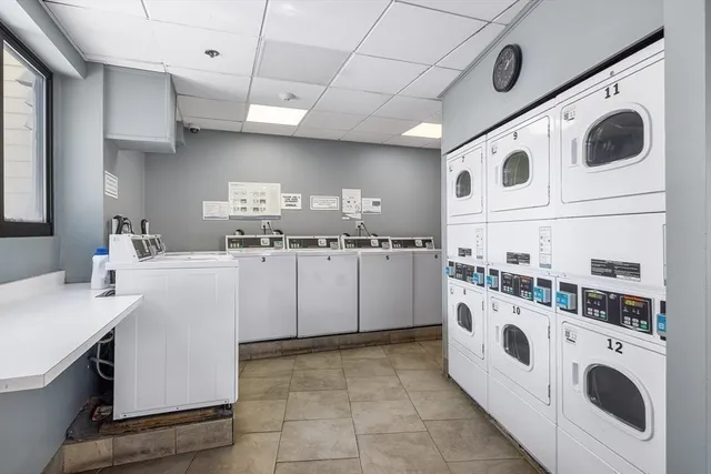 a kitchen with kitchen island a white stove top oven and cabinets