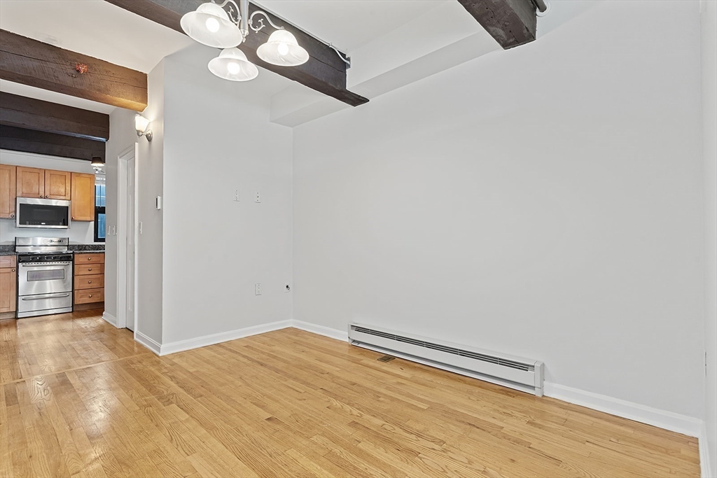 12 Stoneholm Street, Unit 614 Boston, MA 02115 - Photo 2 of 17 a view of empty room with wooden floor