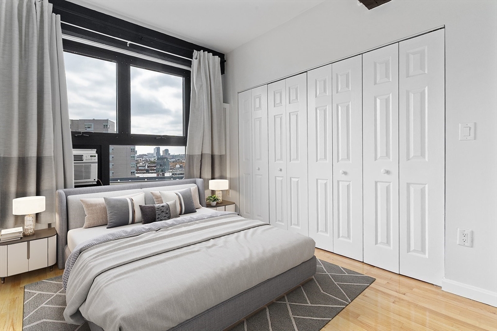 12 Stoneholm Street, Unit 614 Boston, MA 02115 - Photo 8 of 17 a bedroom with a bed and a large window