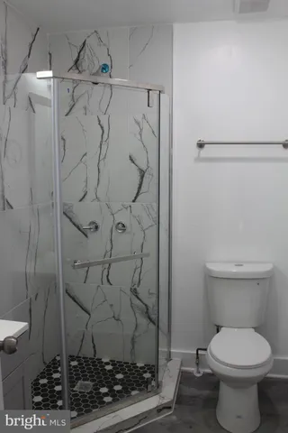 a bathroom with a toilet and a shower