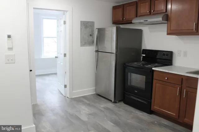 a kitchen with a refrigerator stove and cabinets