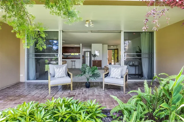 a balcony with furniture and a potted plant