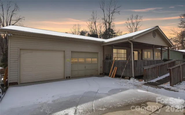 a view of a house with wooden fence