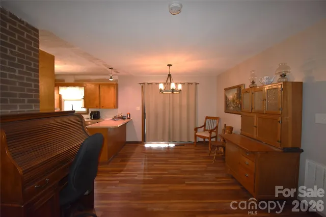 a kitchen view with a table chairs refrigerator and cabinets