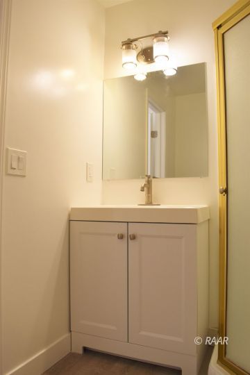 204 North Helena Street Ridgecrest, CA 93555 - Photo 24 of 29 a bathroom with a sink and a mirror