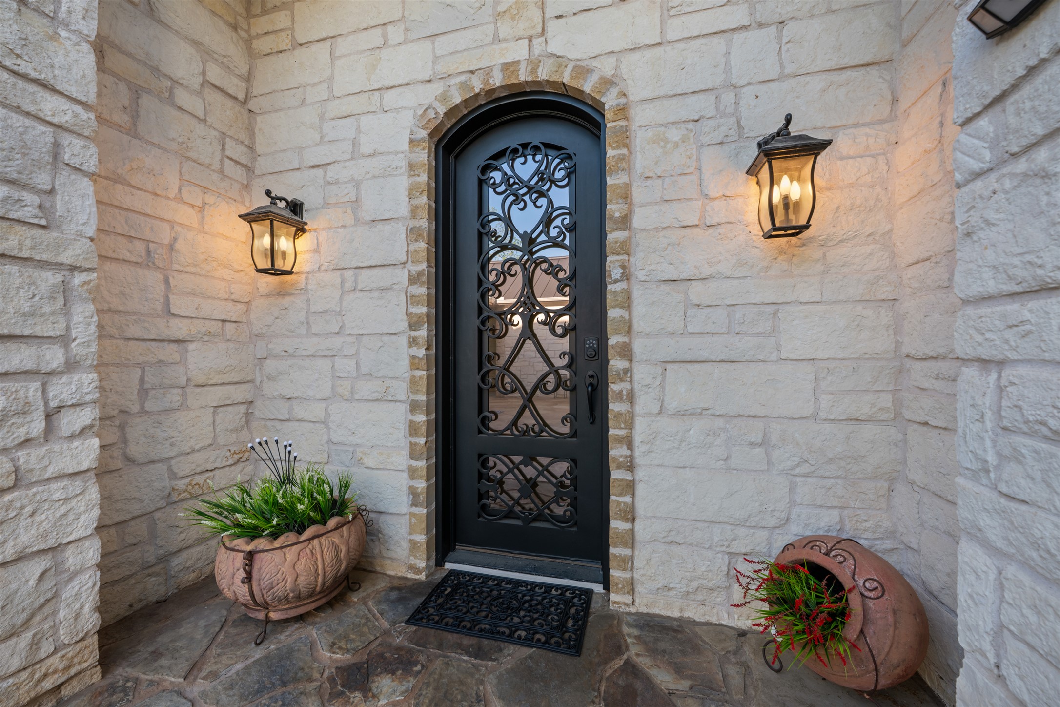 181 Whitney Run Buda, TX 78610 - Photo 9 of 40 Custom wrought iron and glass front door provides an elegant entry to the home.