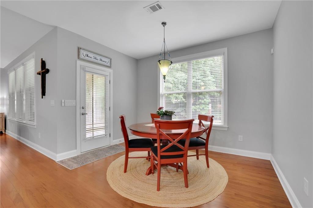 6255 Allison Road Cumming, GA 30040 - Photo 15 of 36 a dining room with furniture window wooden floor