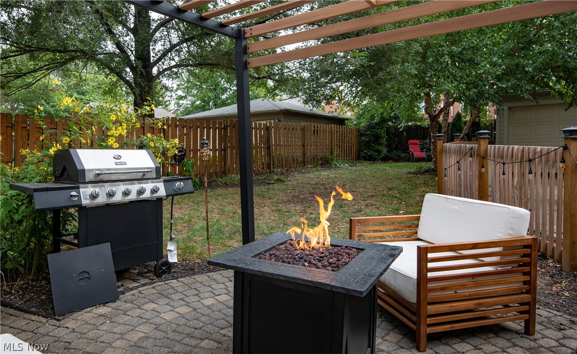 2583 Channing Road Cleveland, OH 44118 - Photo 20 of 21 Sweet, you have to admit. Pergola, grill, fireplace, comfy seating, paver patio - you weren't expecting this were you? Privacy fencing on 1 side, sharp wood fencing finishing the enclosed back yard, there's another paved patio at the back of the yard