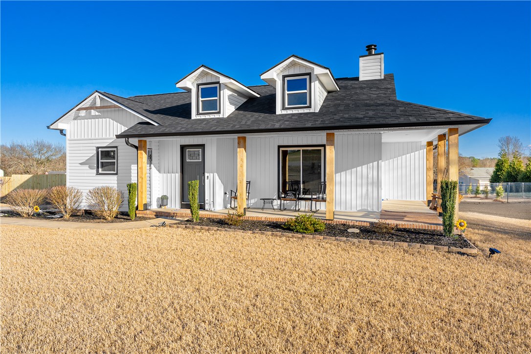 This captivating home features a classic exterior and a welcoming porch.