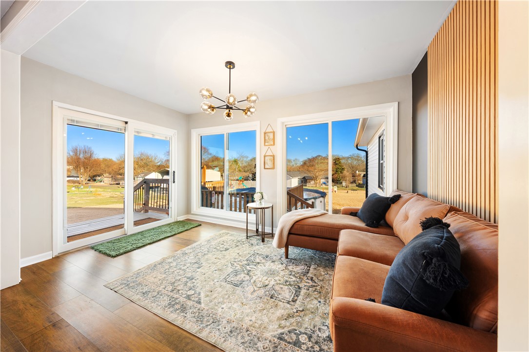 3067 Anderson Highway Liberty, SC 29657 - Photo 16 of 32 This bright living space features expansive windows and rich wood flooring, connecting seamlessly with outdoor views.