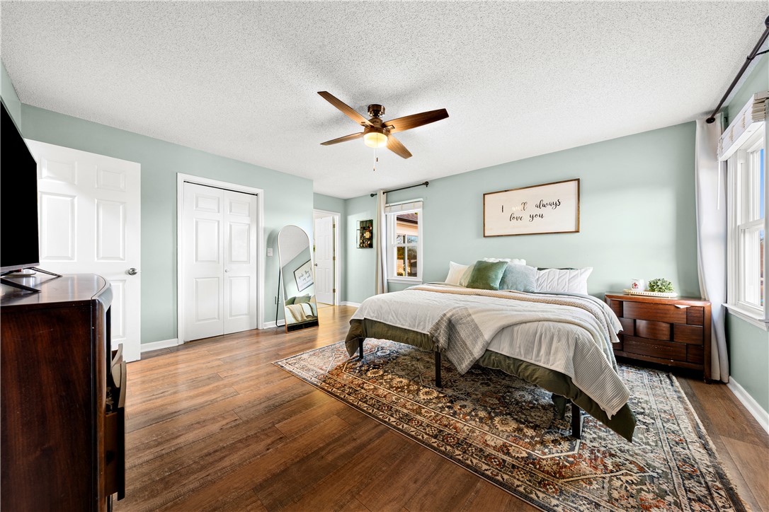 3067 Anderson Highway Liberty, SC 29657 - Photo 19 of 32 This airy bedroom features abundant natural light and warm hardwood flooring.