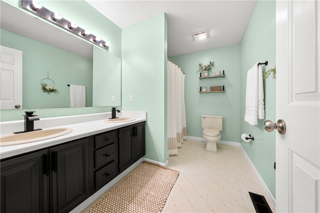 3067 Anderson Highway Liberty, SC 29657 - Photo 20 of 32 This bright bathroom features a spacious dual vanity and a well-appointed shower area.