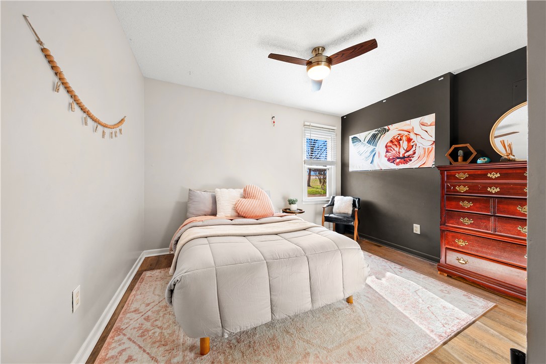 3067 Anderson Highway Liberty, SC 29657 - Photo 22 of 32 This cozy bedroom features a ceiling fan, window, and durable wood flooring.