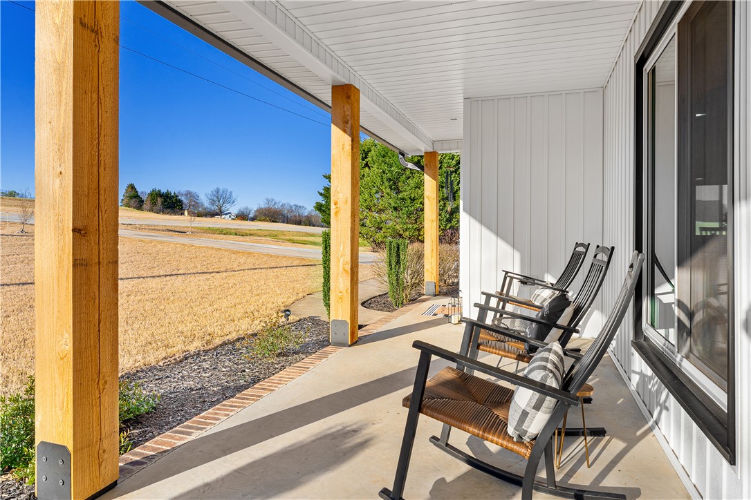 3067 Anderson Highway Liberty, SC 29657 - Photo 3 of 32 Relax on the inviting porch, offering a peaceful retreat with scenic outdoor views.