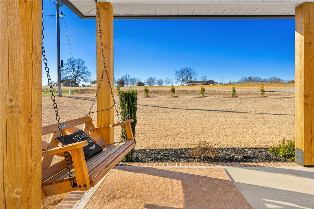 3067 Anderson Highway Liberty, SC 29657 - Photo 4 of 32 Relax on the porch swing and enjoy the expansive views of the natural surroundings.