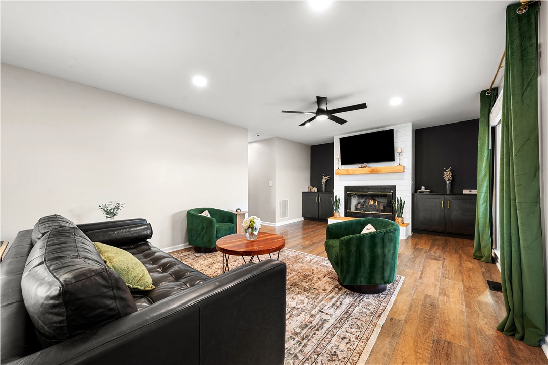 3067 Anderson Highway Liberty, SC 29657 - Photo 6 of 32 This inviting living area features warm wood flooring, a charming fireplace, and abundant natural light.