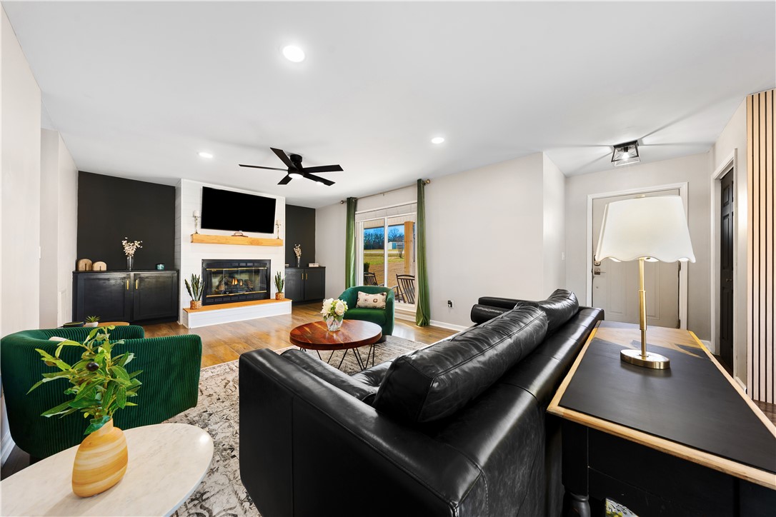 3067 Anderson Highway Liberty, SC 29657 - Photo 7 of 32 This inviting living space features hardwood floors and a cozy fireplace, perfect for gatherings.