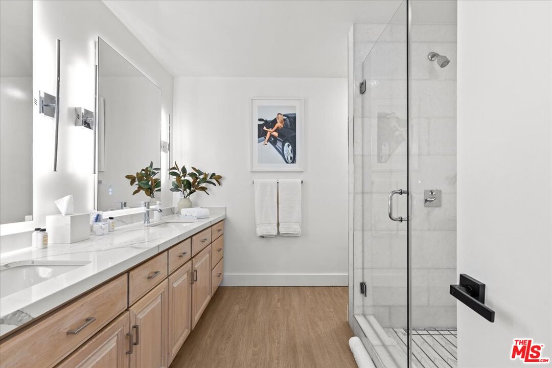 1650 Clear View Drive Beverly Hills, CA 90210 - Photo 13 of 31 a spacious bathroom with a shower and a sink