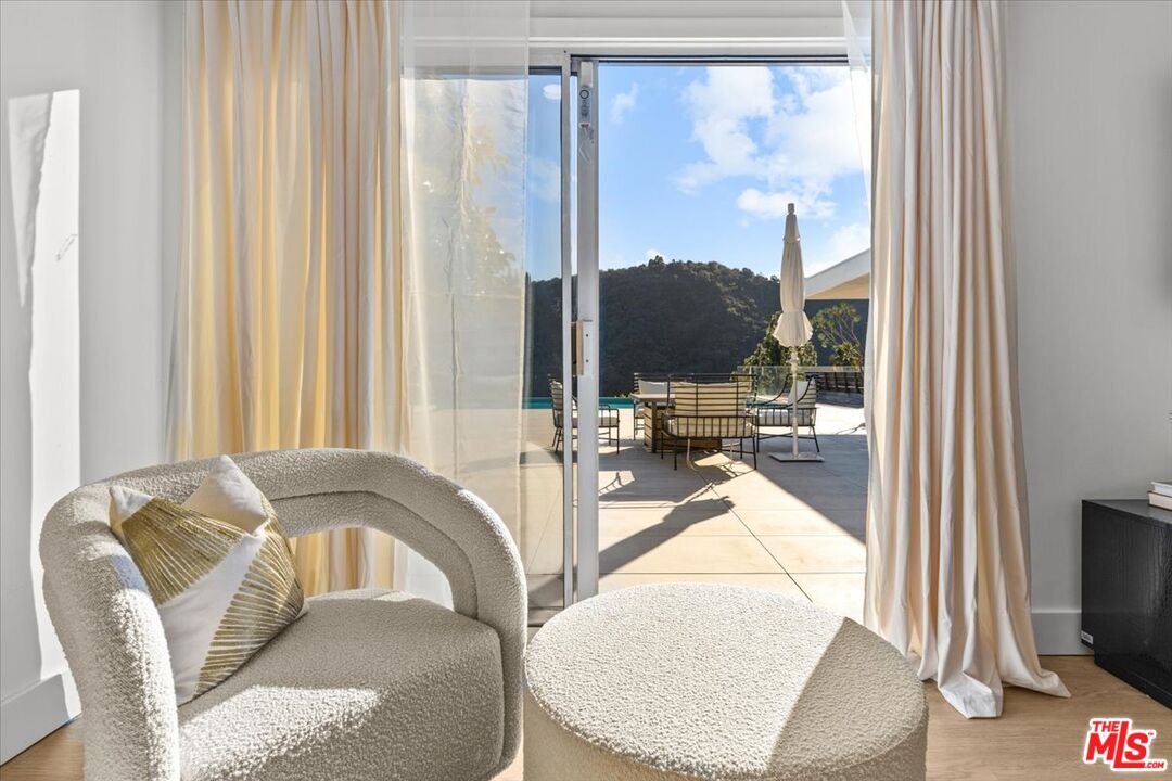 1650 Clear View Drive Beverly Hills, CA 90210 - Photo 14 of 31 a living room with furniture and a flat screen tv