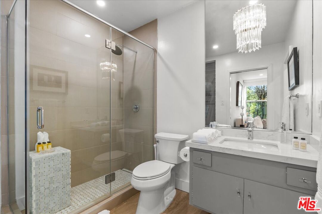 1650 Clear View Drive Beverly Hills, CA 90210 - Photo 16 of 31 a bathroom with a sink a toilet and shower