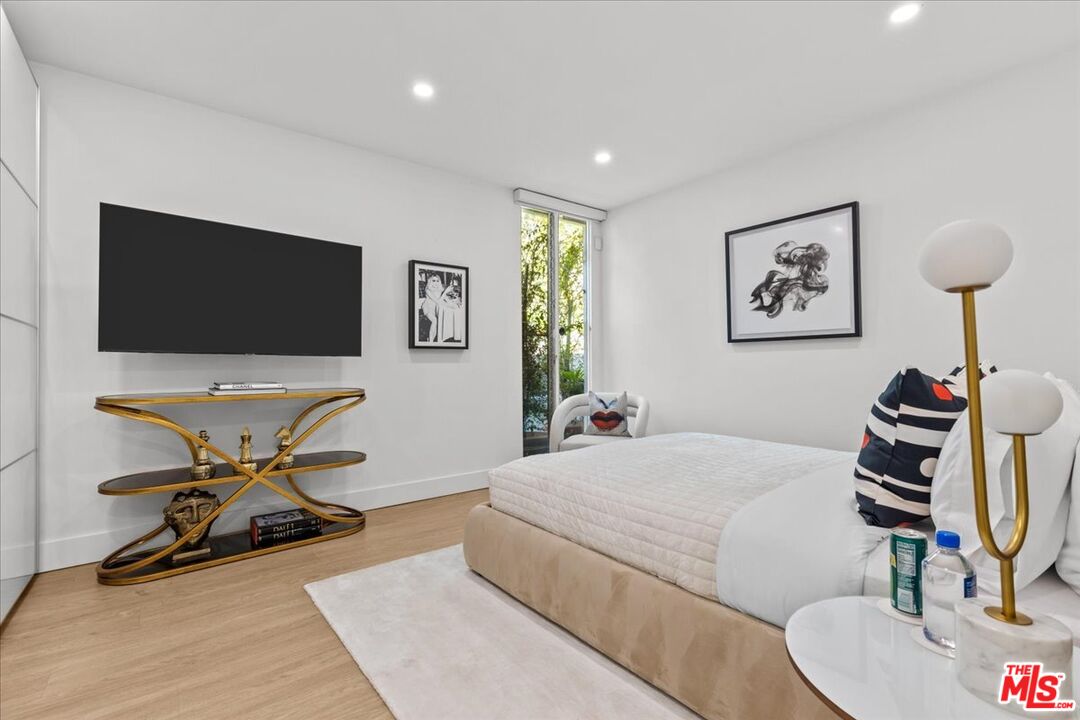 1650 Clear View Drive Beverly Hills, CA 90210 - Photo 18 of 31 a bedroom with furniture and a flat screen tv