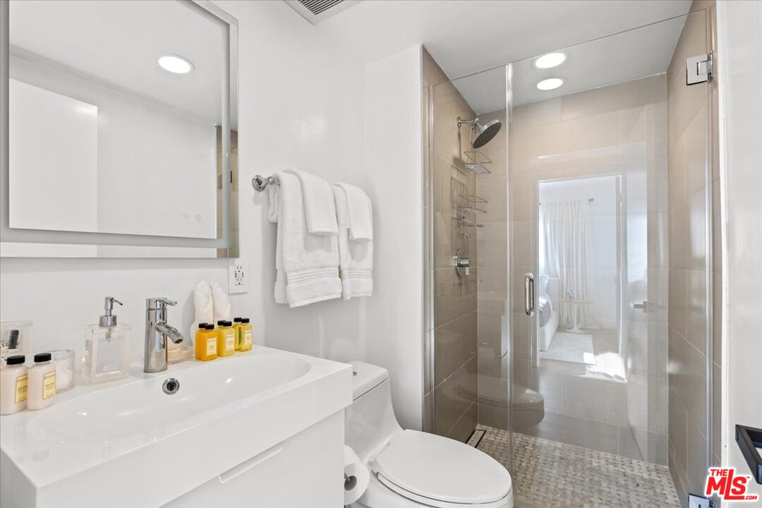 1650 Clear View Drive Beverly Hills, CA 90210 - Photo 20 of 31 a bathroom with a sink toilet and shower