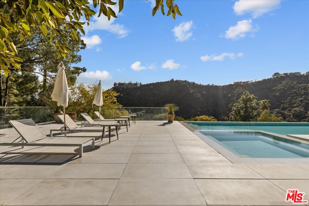 1650 Clear View Drive Beverly Hills, CA 90210 - Photo 22 of 31 a view of outdoor space with swimming pool and trees
