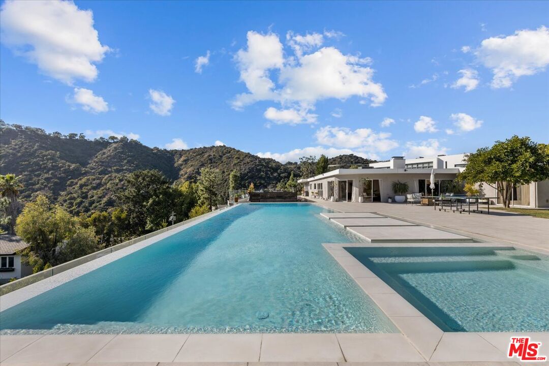 1650 Clear View Drive Beverly Hills, CA 90210 - Photo 26 of 31 a front view of a house with a yard