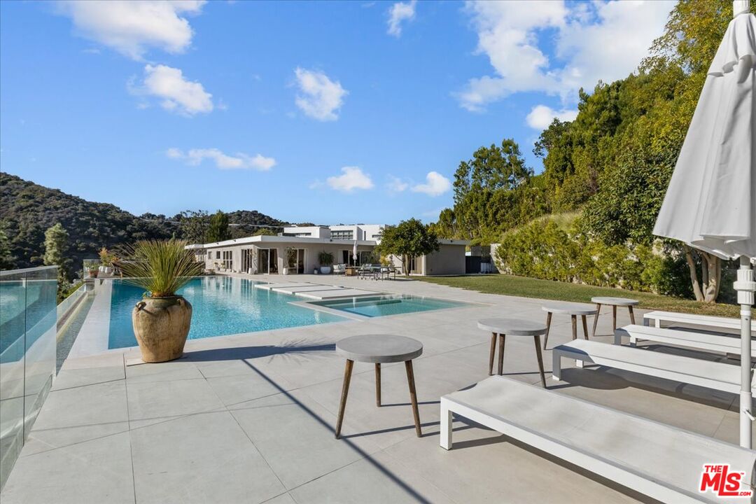 1650 Clear View Drive Beverly Hills, CA 90210 - Photo 28 of 31 a terrace with outdoor seating and city view