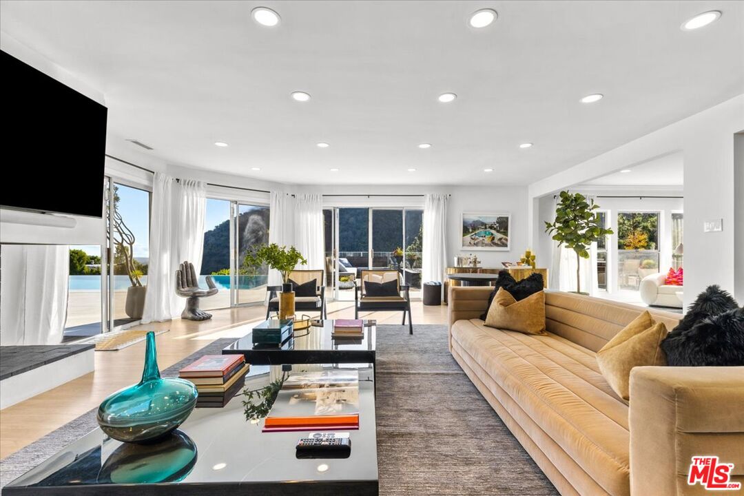 1650 Clear View Drive Beverly Hills, CA 90210 - Photo 3 of 31 a living room with fireplace furniture and a flat screen tv