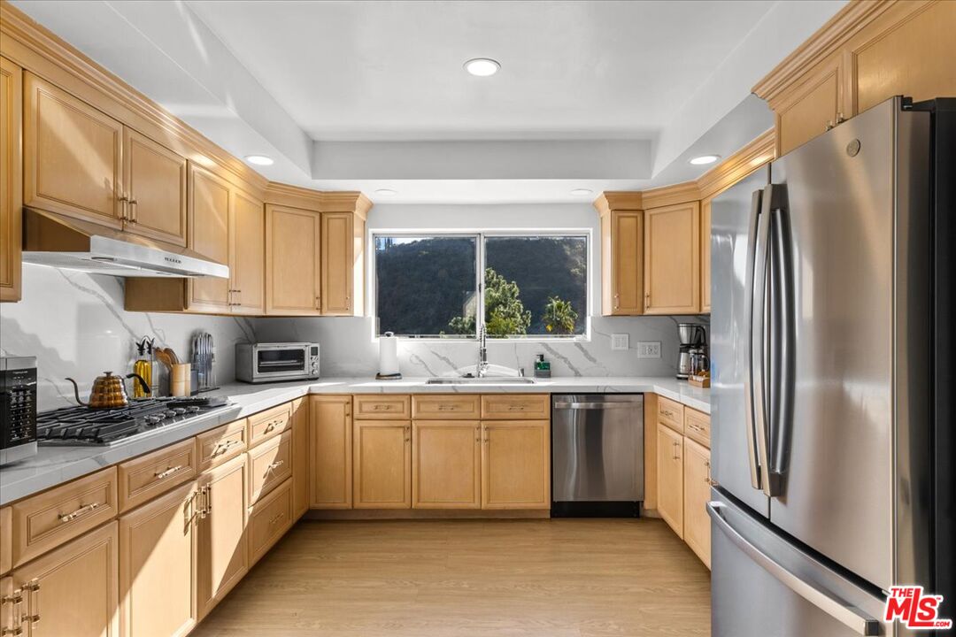 1650 Clear View Drive Beverly Hills, CA 90210 - Photo 5 of 31 a large kitchen with stainless steel appliances a sink and cabinets