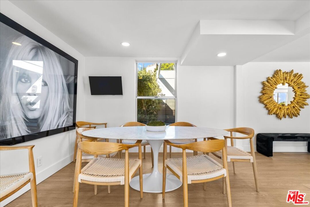 1650 Clear View Drive Beverly Hills, CA 90210 - Photo 7 of 31 a view of a dining room with furniture and wooden floor