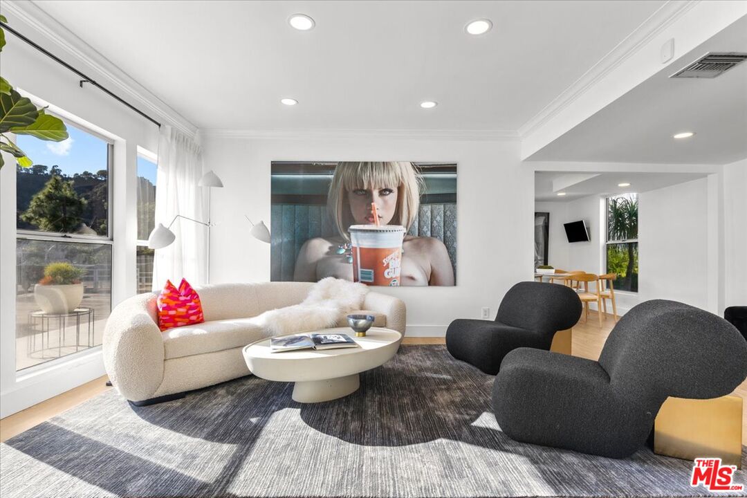 1650 Clear View Drive Beverly Hills, CA 90210 - Photo 9 of 31 a living room with furniture and a large window