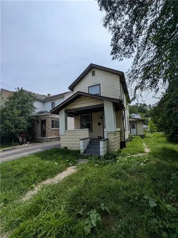 a front view of a house with a garden
