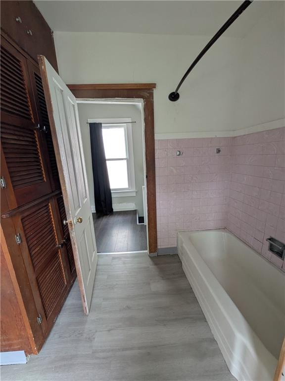 508 Electric Street New Castle, PA 16101 - Photo 11 of 14 a view of a hallway with wooden floor and staircase