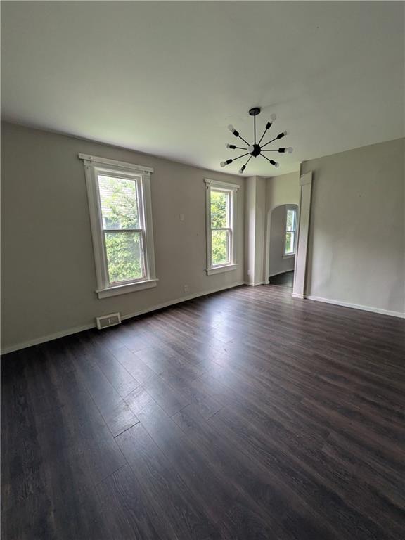 508 Electric Street New Castle, PA 16101 - Photo 4 of 14 an empty room with wooden floor chandelier fan and windows