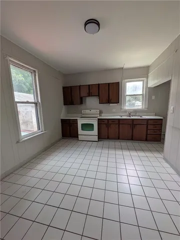 a kitchen with stainless steel appliances a sink and cabinets