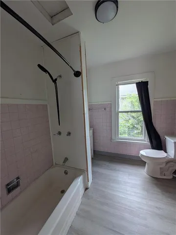 a bathroom with a tub sink and a toilet