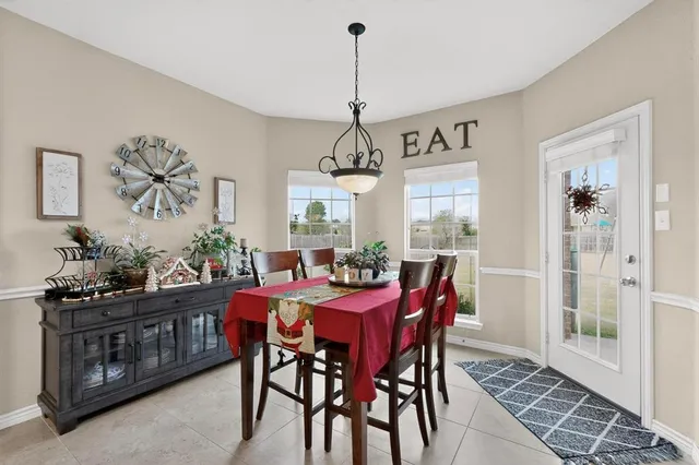 a dining room with furniture window and wooden floor