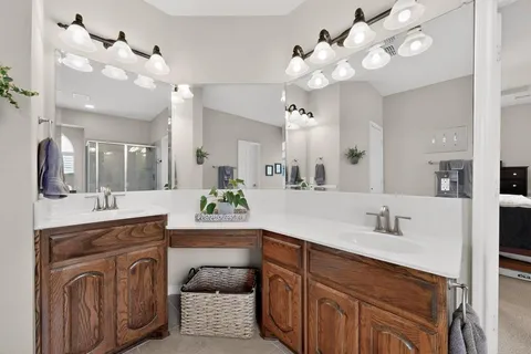 a spacious bathroom with a granite countertop double vanity sink and a mirror