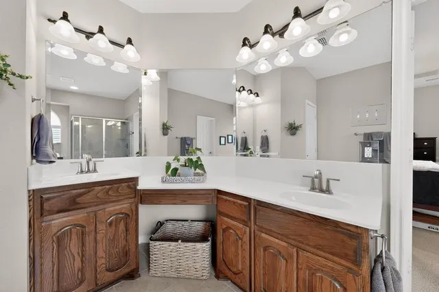a spacious bathroom with a granite countertop double vanity sink and a mirror