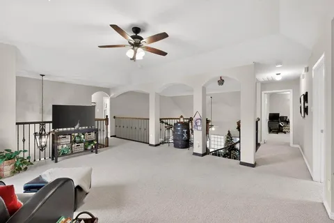 a view of a livingroom with furniture and a flat screen tv