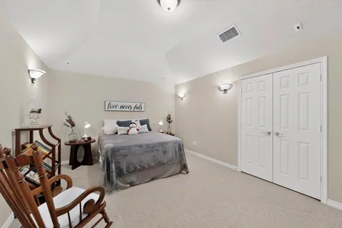 a bedroom with two beds and a chandelier