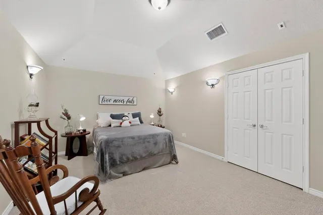 a bedroom with two beds and a chandelier
