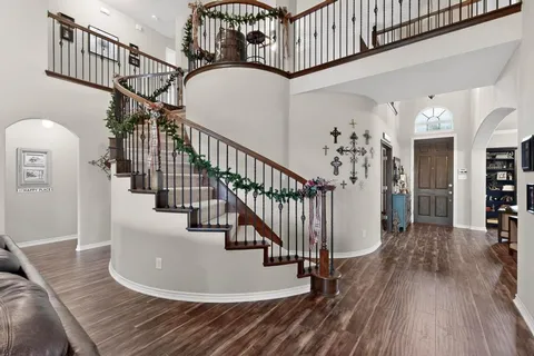 a view of entryway and hall with wooden floor