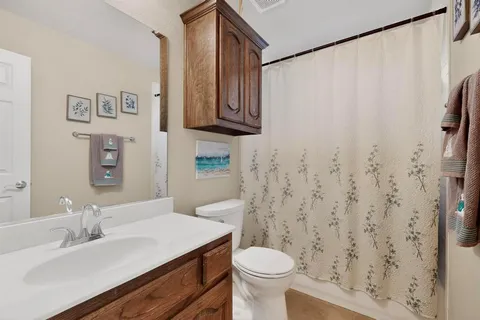 a bathroom with a sink toilet and a mirror