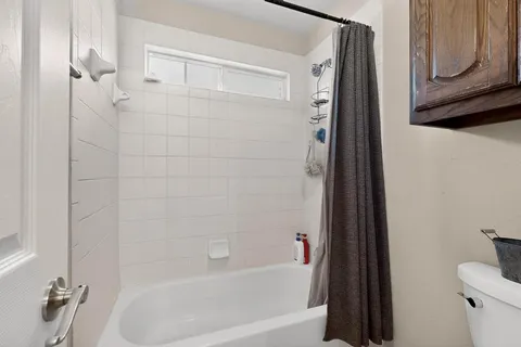 a bathroom with a bathtub and a shower