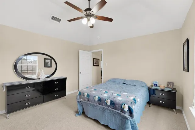 a bedroom with a bed and a dresser