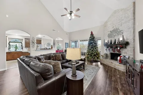 a living room with furniture a chandelier and a flat screen tv
