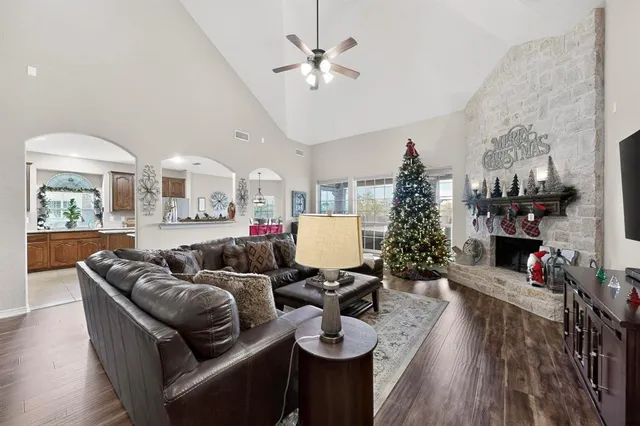 a living room with furniture a chandelier and a flat screen tv